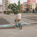 Female on bicycle crossing